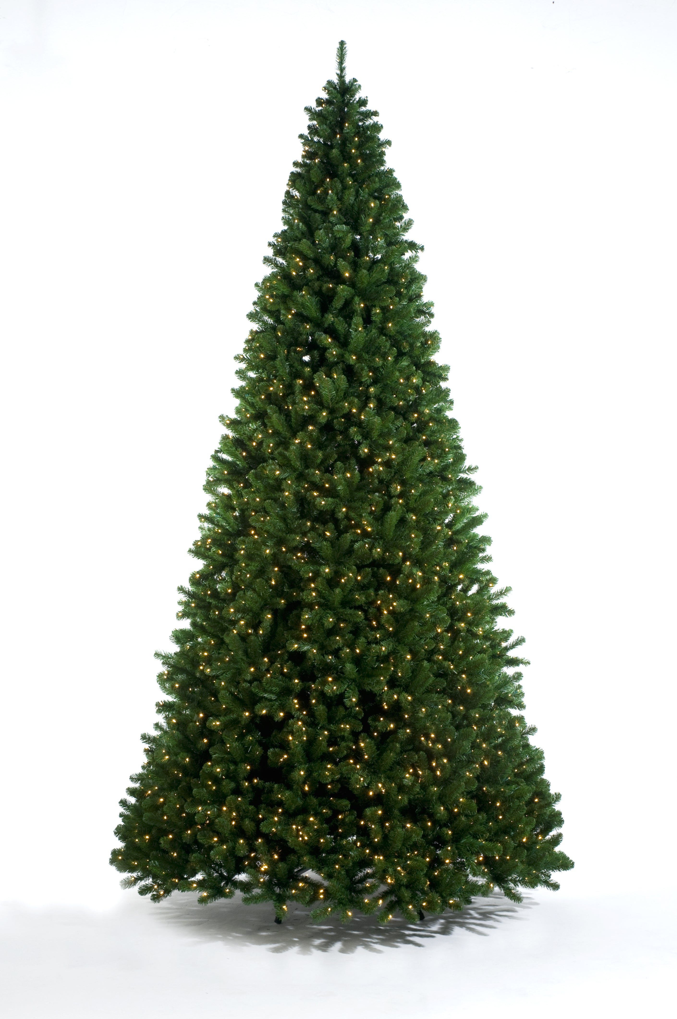 Pre-lit Christmas tree with green needles on a white background